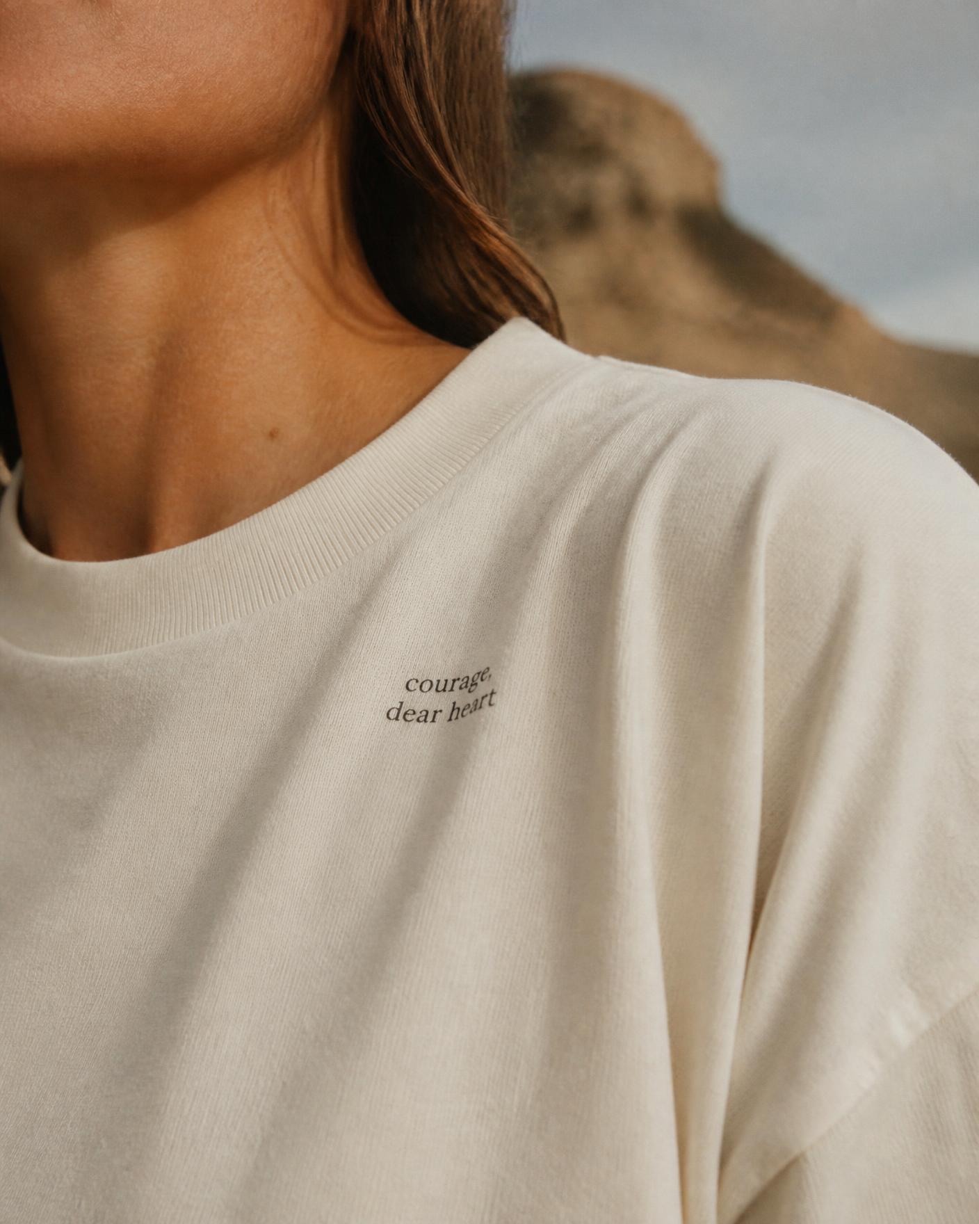 Bone-white heavyweight tee with a small reminder printed at the collarbone