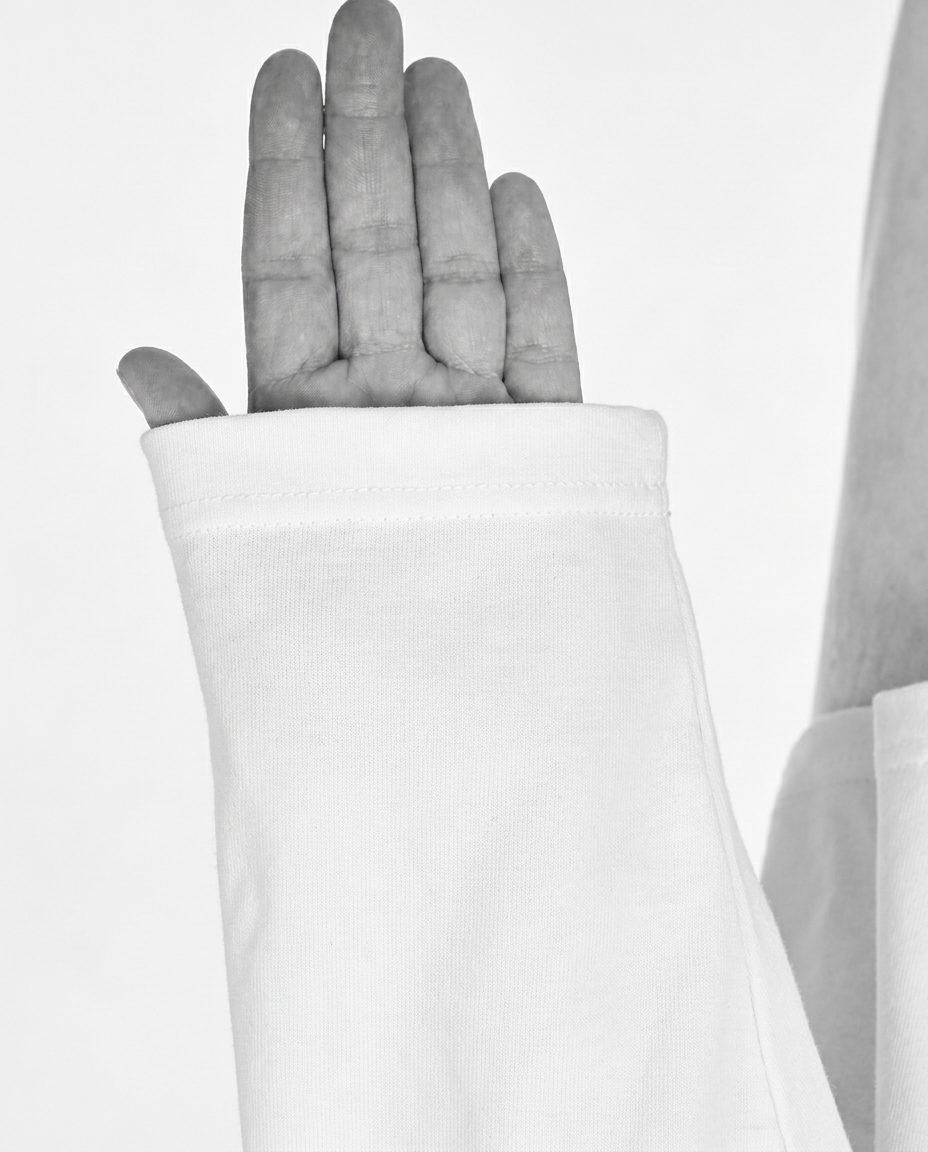 White long sleeve with “courage, dear heart” printed above the left cuff